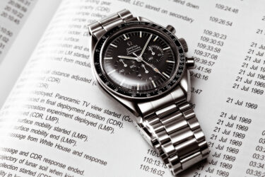 Omega Watch on top of newspaper